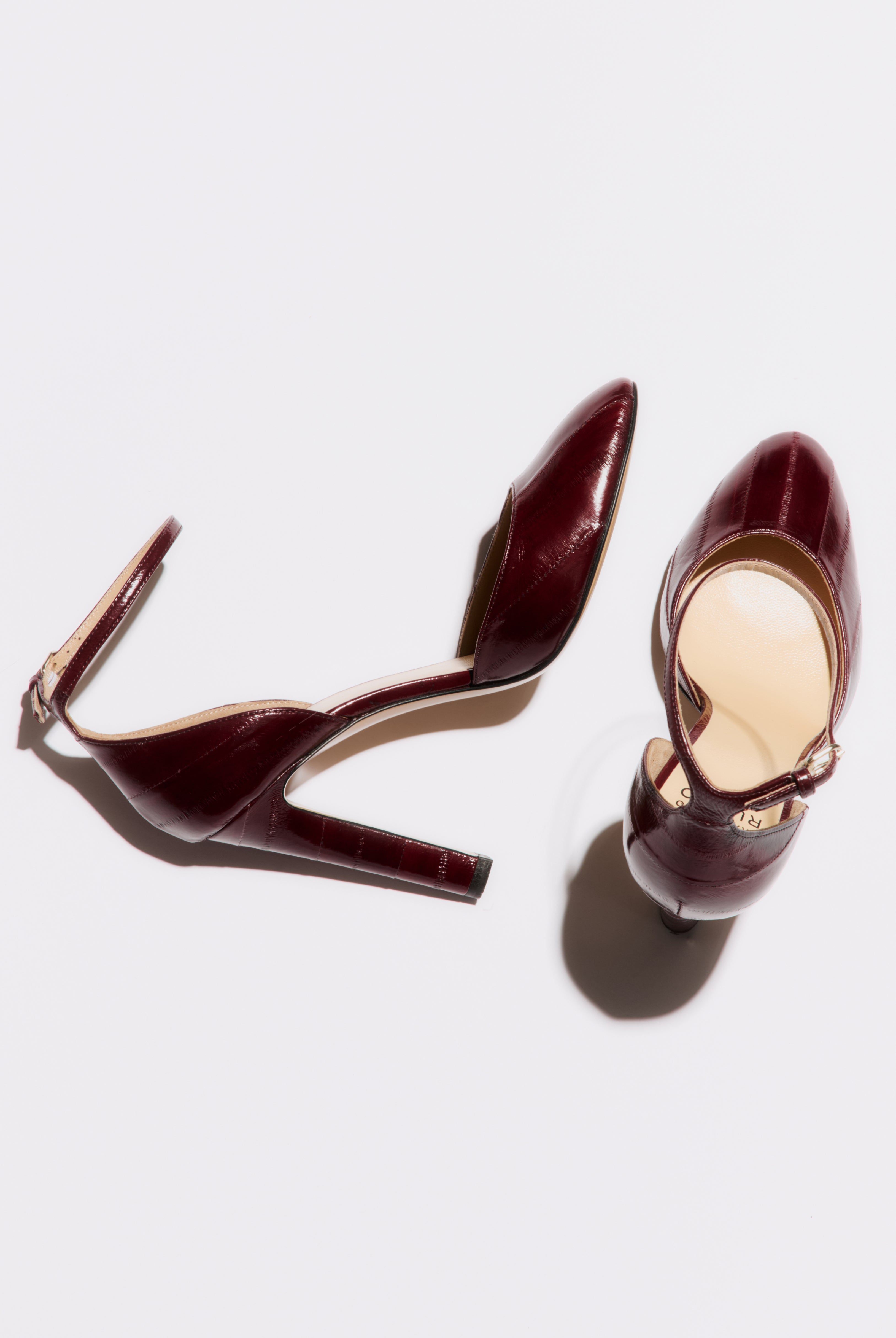 Pair of brown high-heeled shoes on a white background