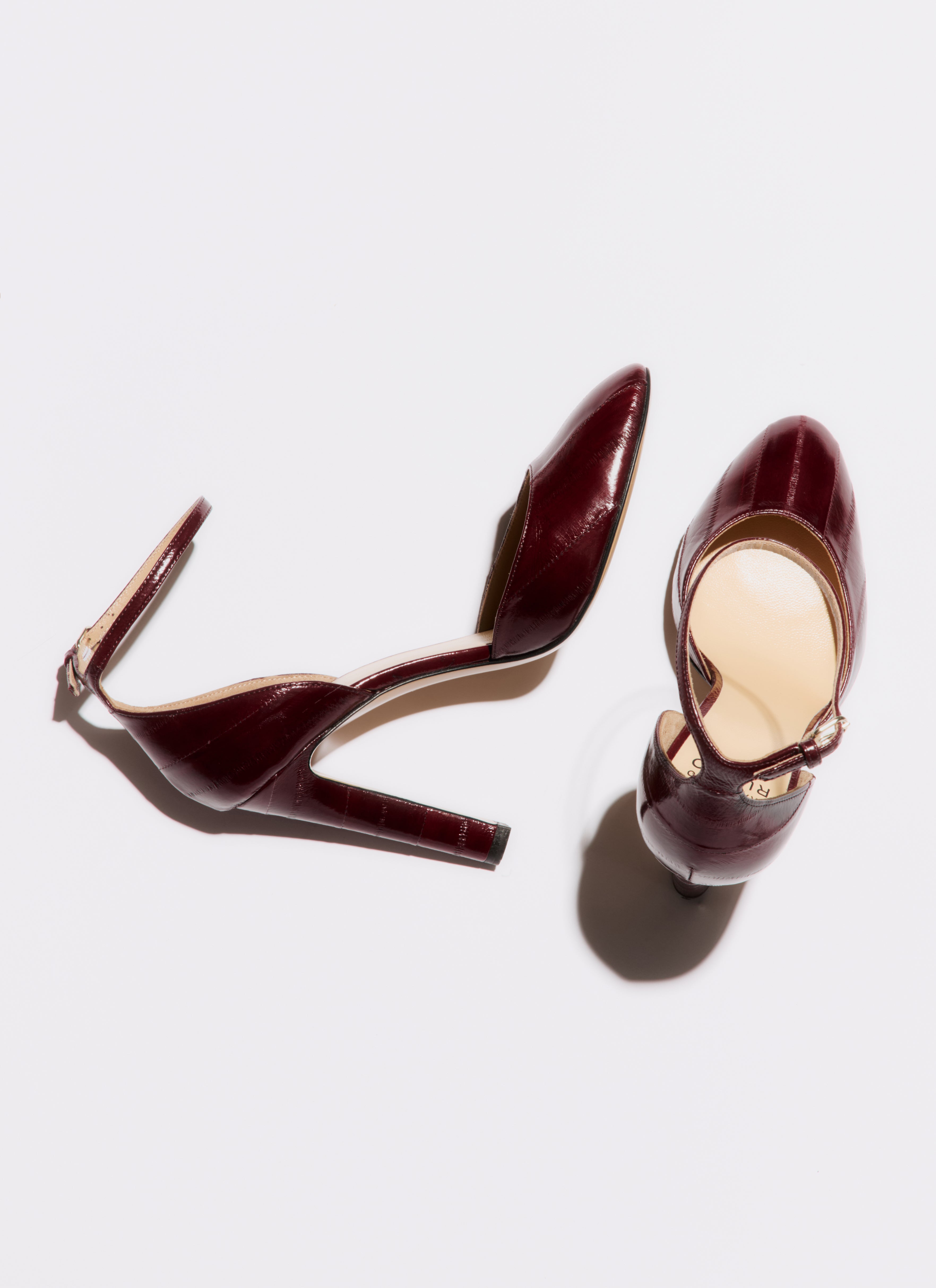 Pair of brown high-heeled shoes on a white background