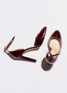Pair of brown high-heeled shoes on a white background
